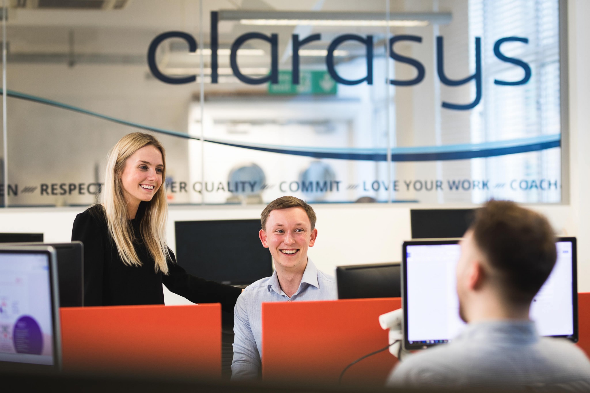 young company male & female in office smiling