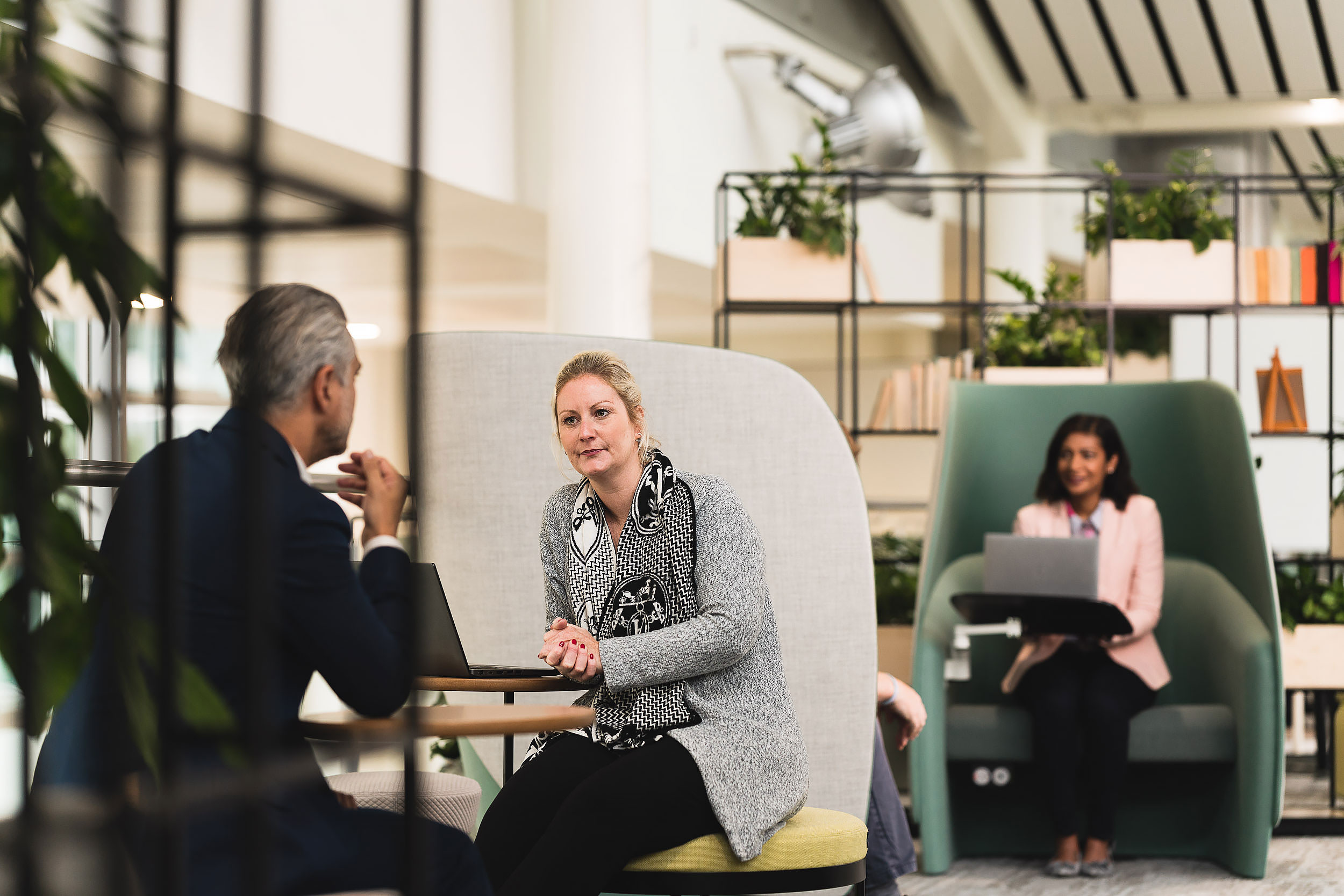 corporate staff talking in contemporary open plan office