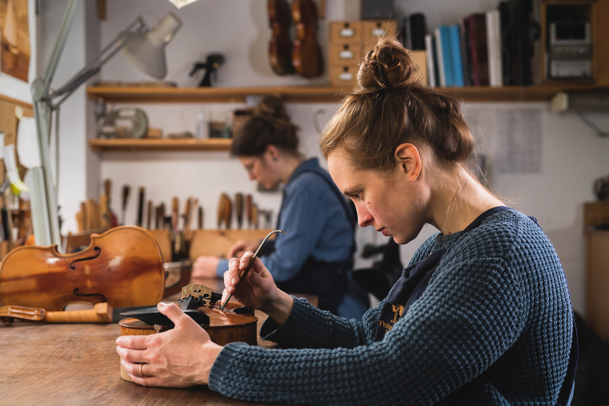 Artisans in London violin making workshop