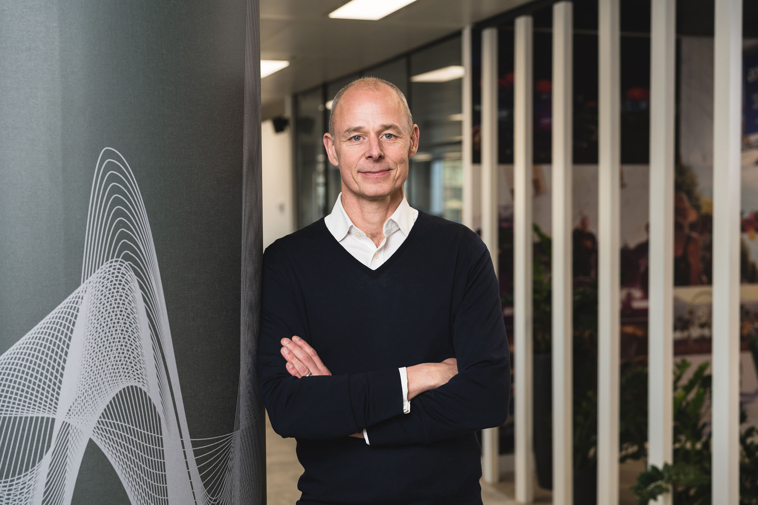 relaxed corportate portrait of male in modern office