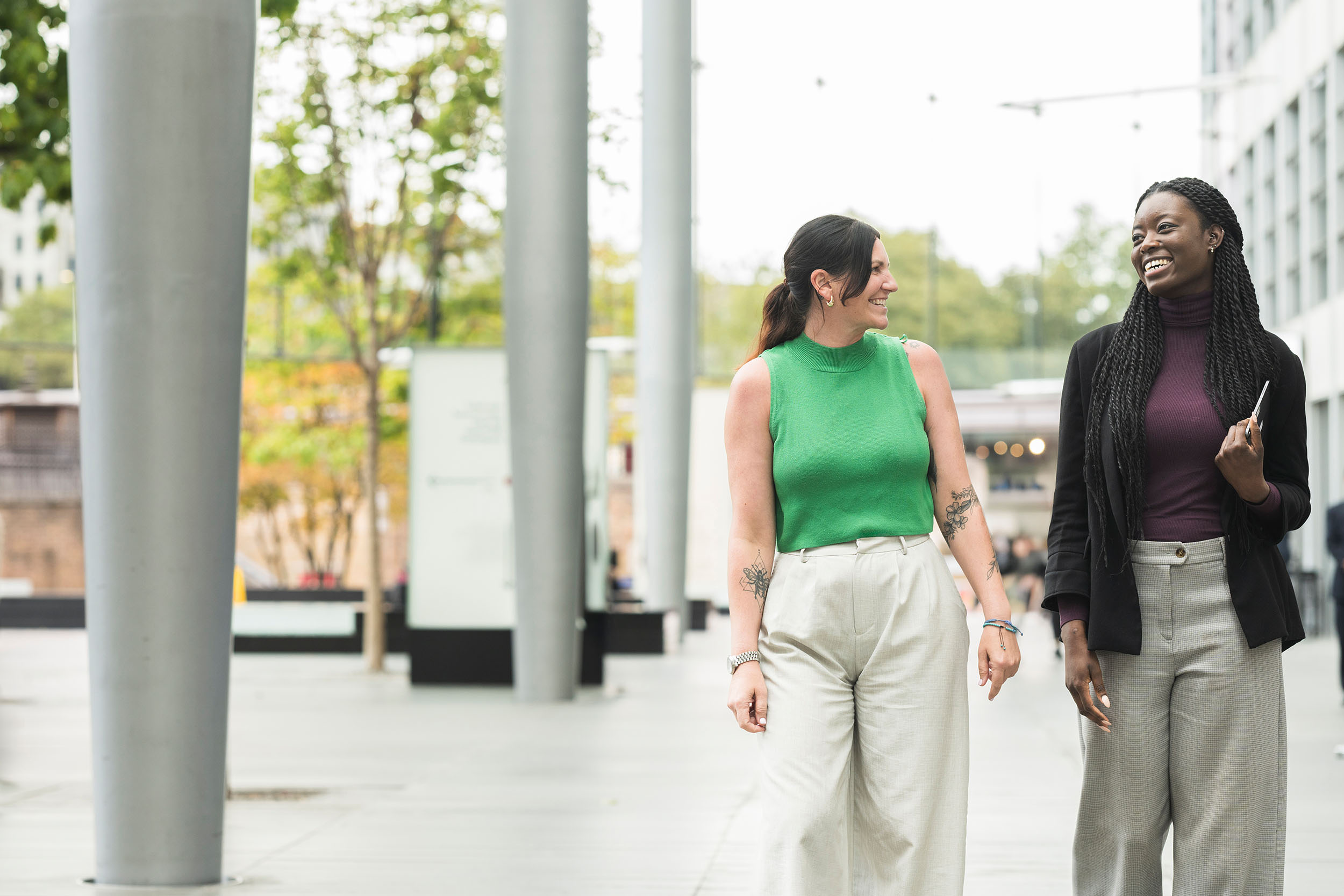 young casual female professionals talking outside office